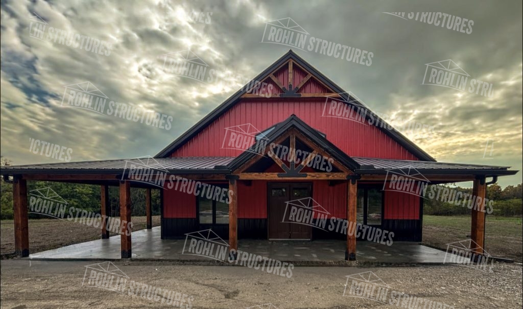 Rohlin Structures barndominium with timber frame accents, wraparound porch, and red siding.