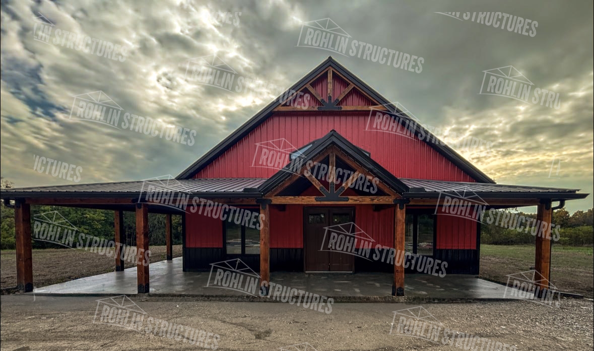 Timber Crest barndominium with timber frame accents and wraparound porch, built by Rohlin Structures.