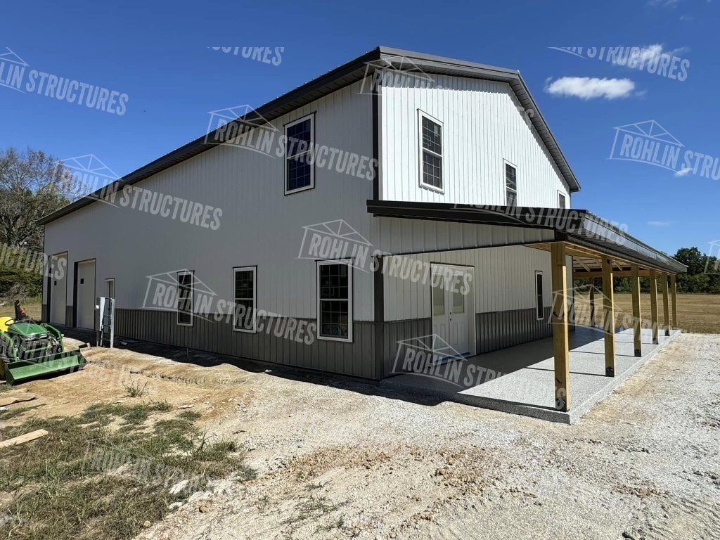 Rohlin Structures Harvest Ridge building package with wraparound porch and garage doors.