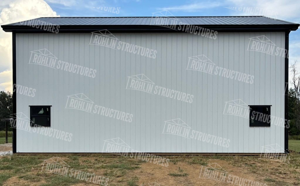 Rohlin Structures barndominium exterior with gray siding and black trim, showcasing a completed building shell.