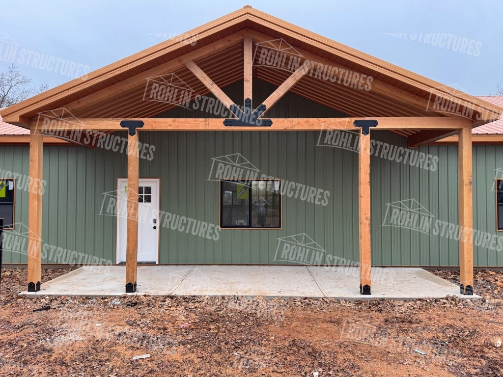 Rohlin Structures barndominium with timber framing and porch, showcasing durable construction.