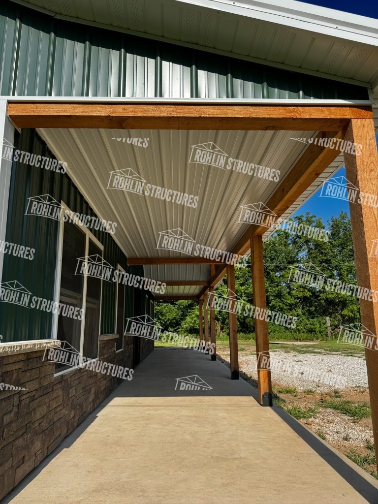 Rohlin Structures pole barn with timber frame accents and front porch detail.