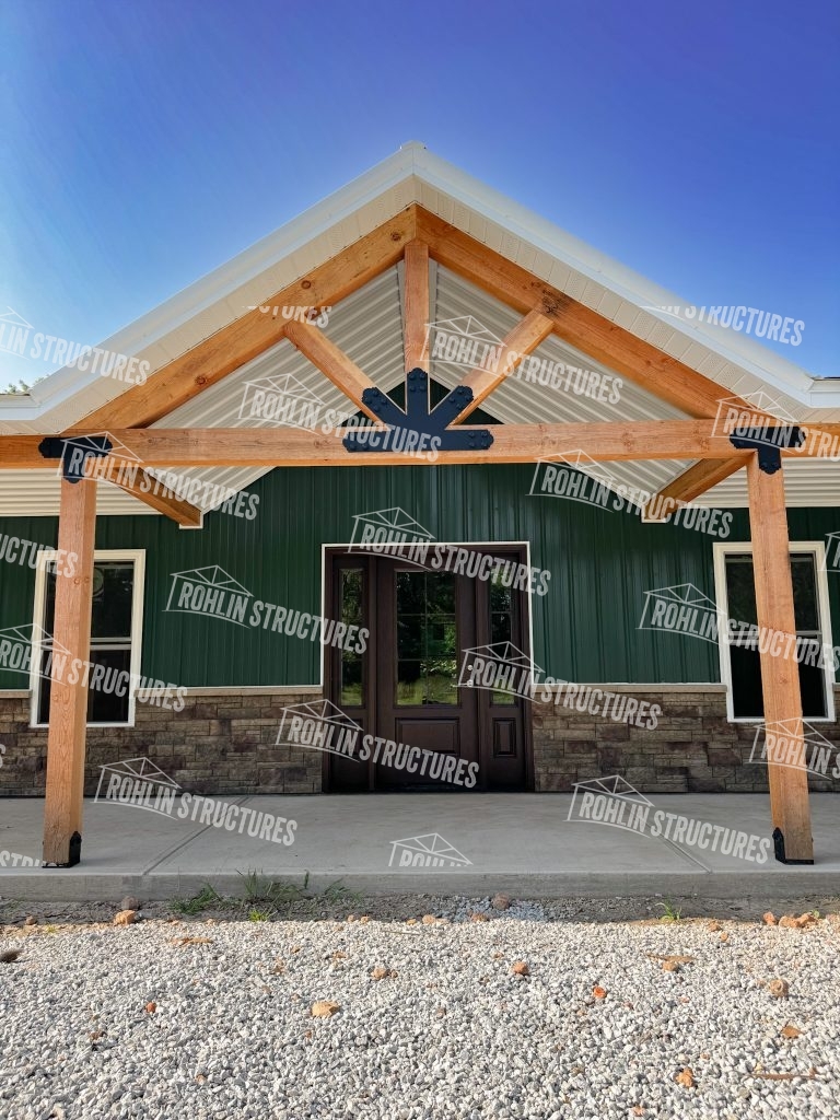Custom barndominium with timber framing and stone accents by Rohlin Structures in Missouri.