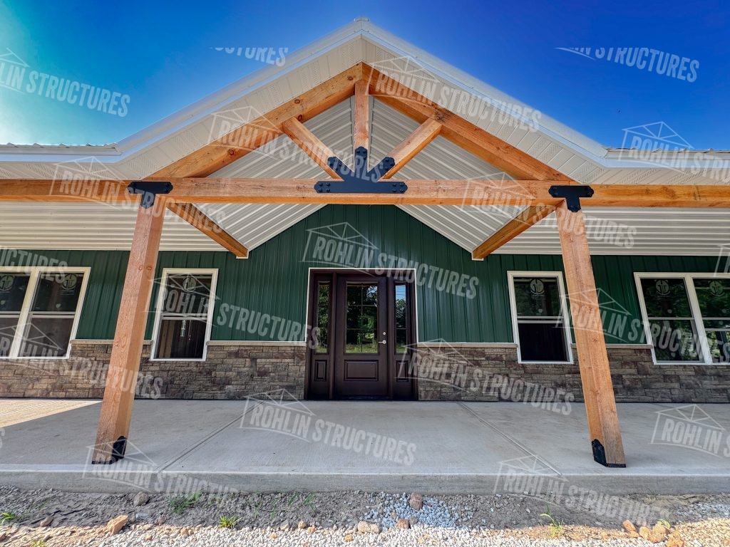 Custom barndominium with timber frame accents and front porch, built by Rohlin Structures in Missouri.