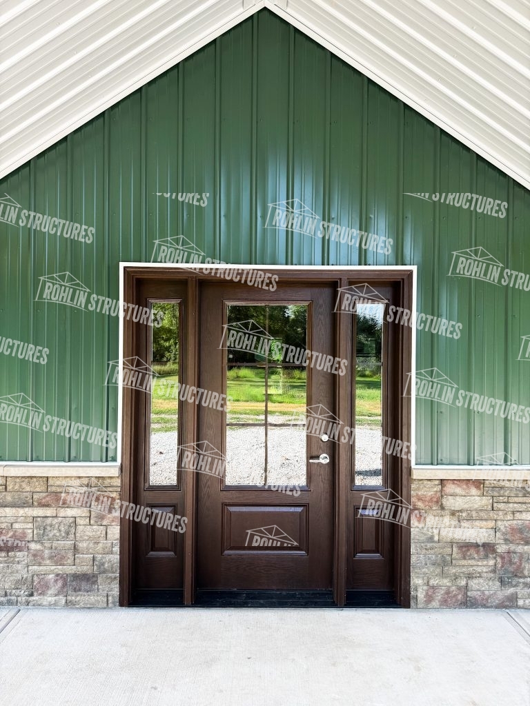 Rohlin Structures pole barn with custom entry door and stone accents, showcasing quality construction in Missouri.