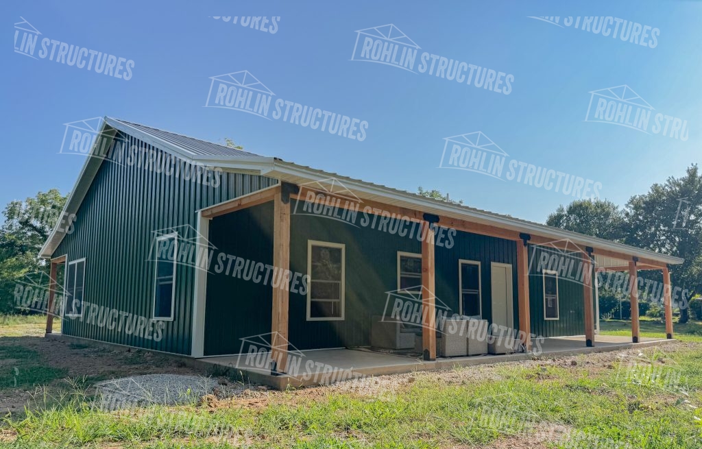 Rohlin Structures custom barndominium with front and back porches and green siding.