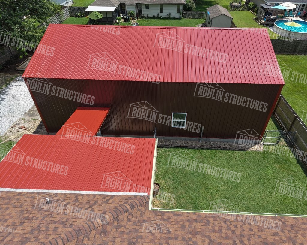 Rohlin Structures garage with red metal roof and siding, showcasing custom pole structure construction in Missouri.