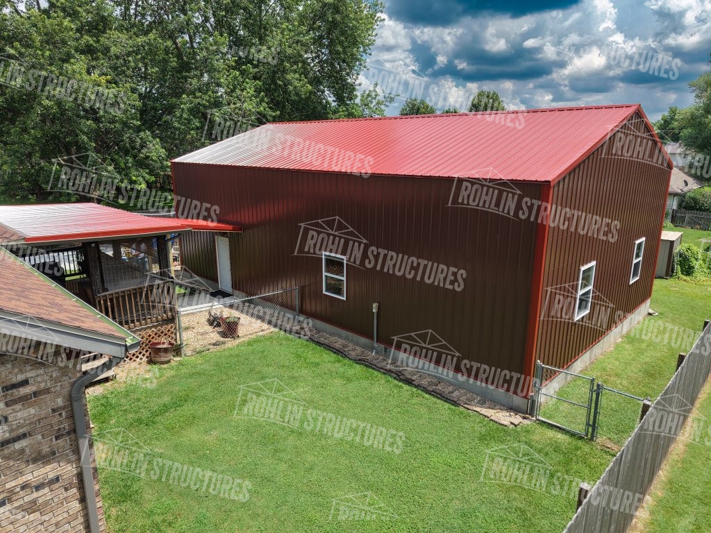 Custom garage with red metal roofing and siding, built by Rohlin Structures in Missouri.