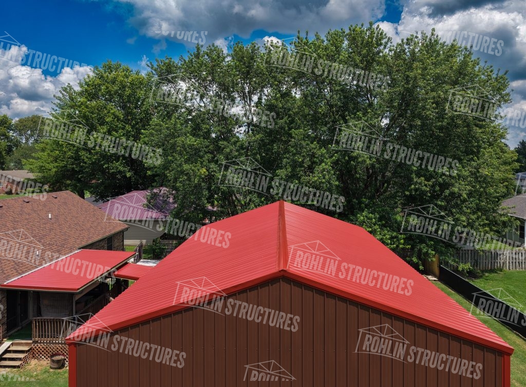 Red metal roof and siding on a custom garage by Rohlin Structures in Missouri.