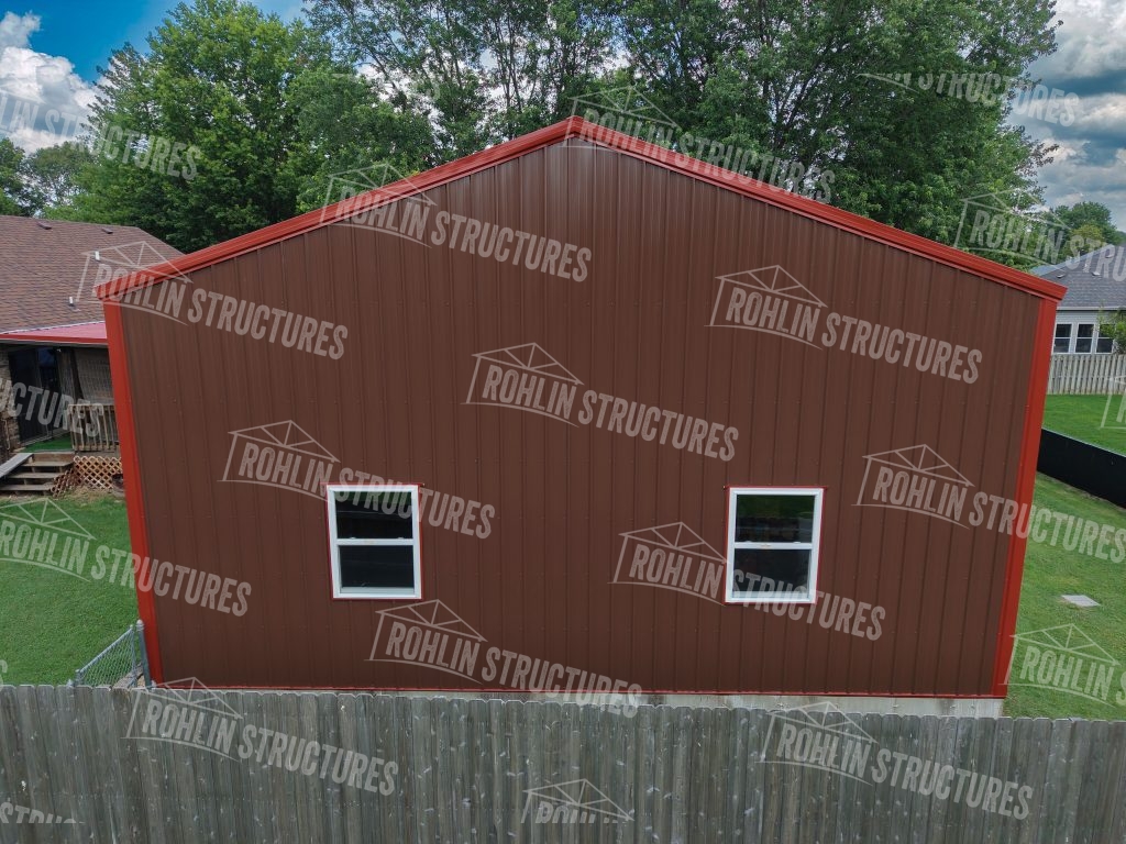 Rohlin Structures garage with red siding and white-framed windows, showcasing custom building options in Missouri.