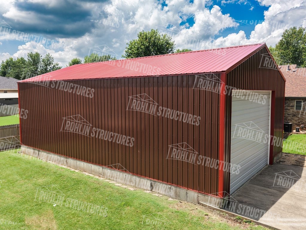 Rohlin Structures pole barn with red roof and gray garage door, showcasing custom building options