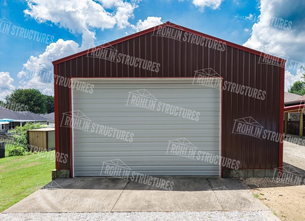 Rohlin Structures custom garage with red and brown metal siding and white roll-up door.