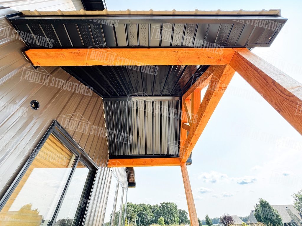 Custom barndominium construction detail showcasing Rohlin Structures timber framing and metal roofing in Missouri.
