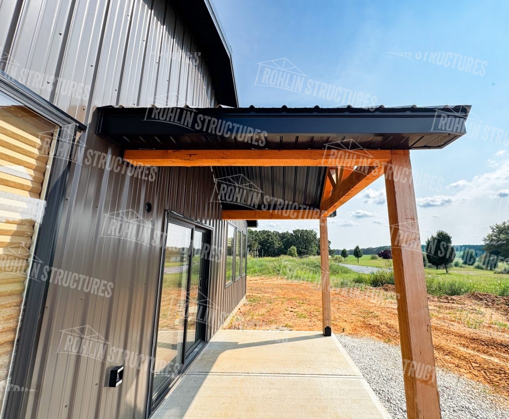 Rohlin Structures barndominium construction with timber frame porch and metal siding in Missouri.