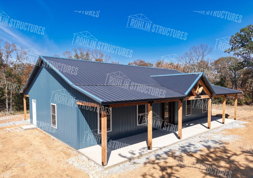 A blue metal-roofed house featuring a spacious covered porch
