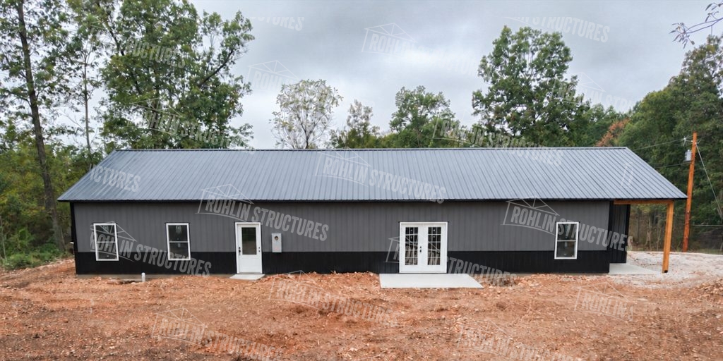 A Rohlin Structures pole barn featuring dark siding and grey metal roofing, showcasing durable construction.