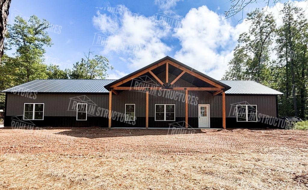 Custom barndominium featuring timber framing and a front porch, showcasing Rohlin Structures’ quality craftsmanship.