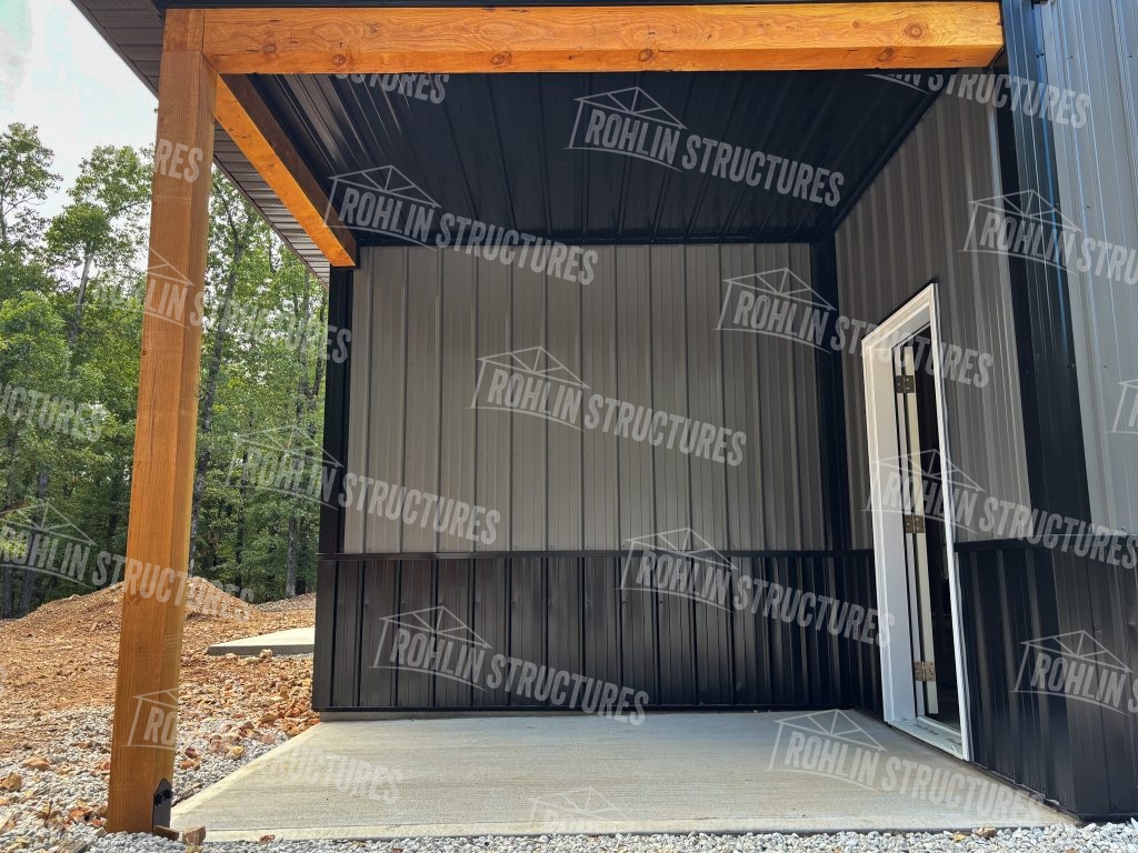 Custom barndominium under construction by Rohlin Structures in Missouri, showcasing a front porch and timber framing.
