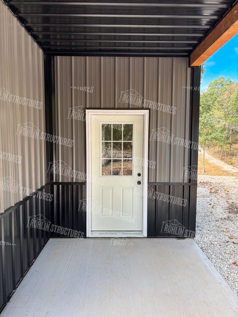 Newly constructed pole barn by Rohlin Structures in Missouri features a white door with tan and brown siding.