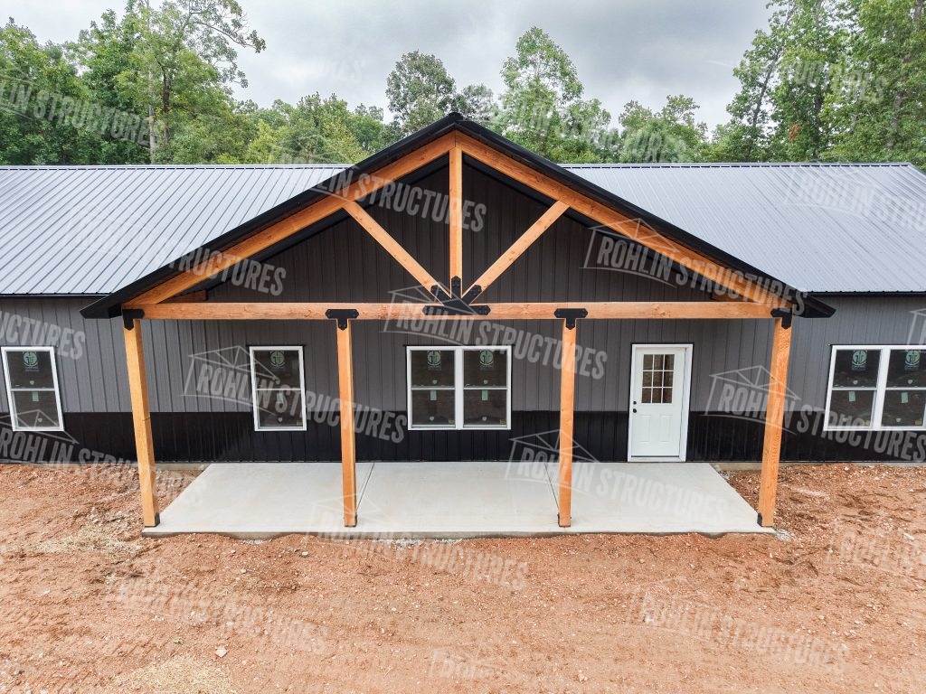 Newly constructed Rohlin Structures barndominium featuring timber framing and a front porch.