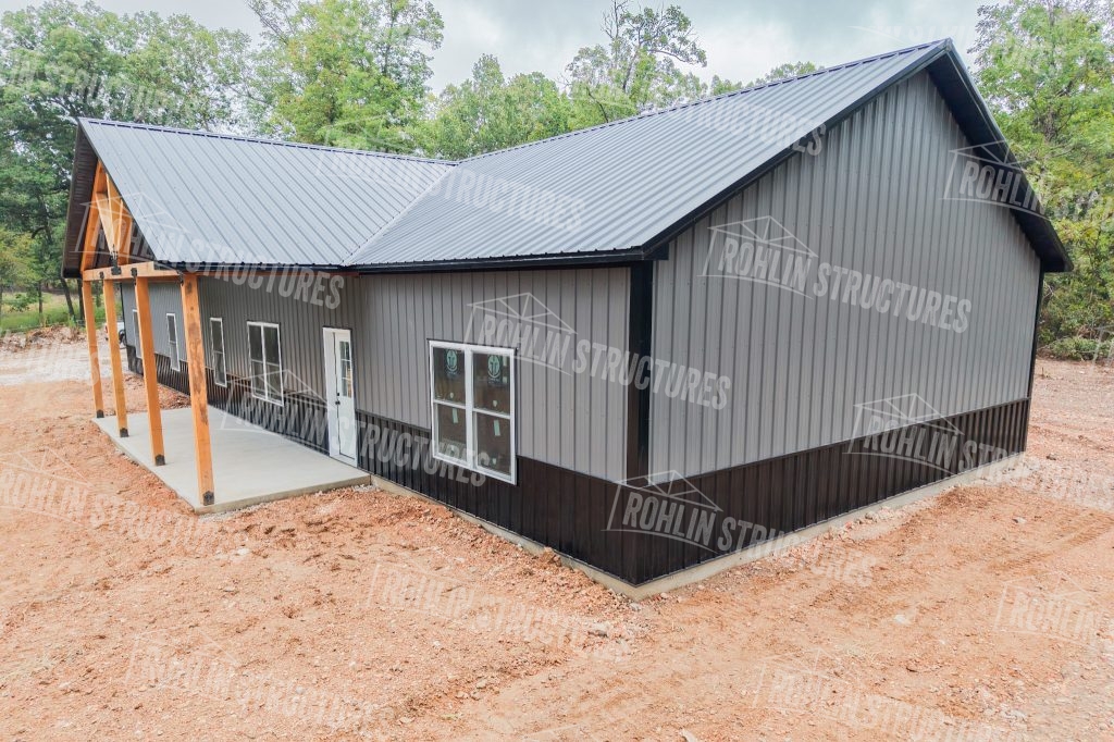 Customizable barndominium built by Rohlin Structures in Missouri, featuring a front porch and dark metal roof and siding.