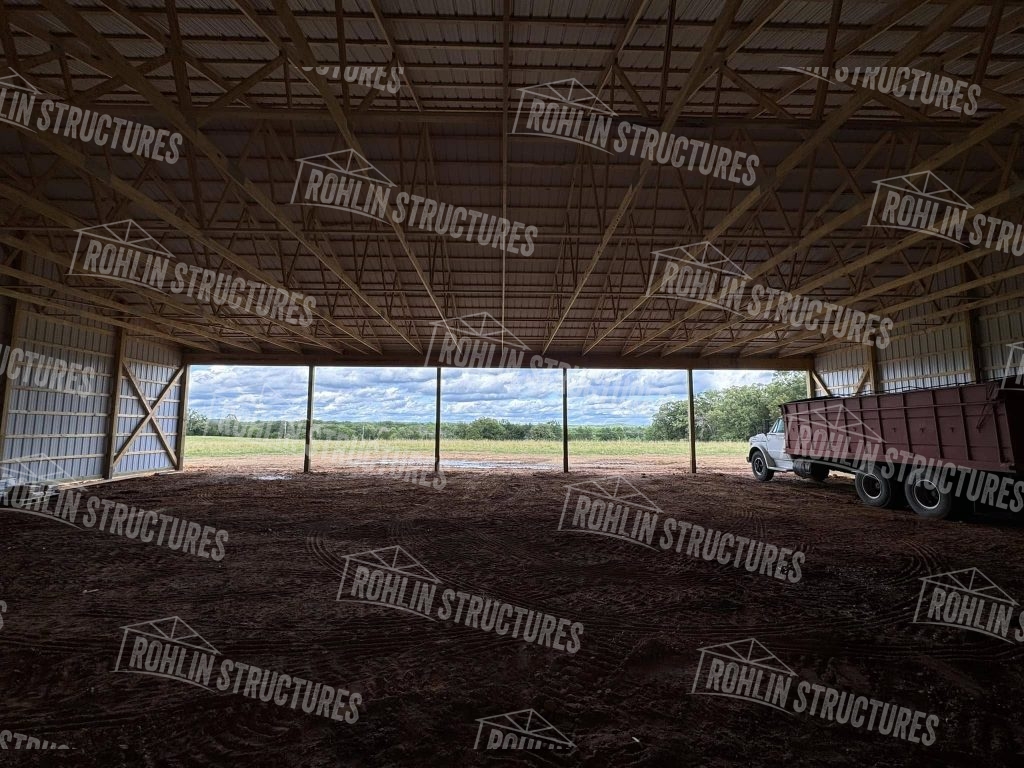 Rohlin Structures equipment cover featuring a large, open post-frame structure with a metal roof.