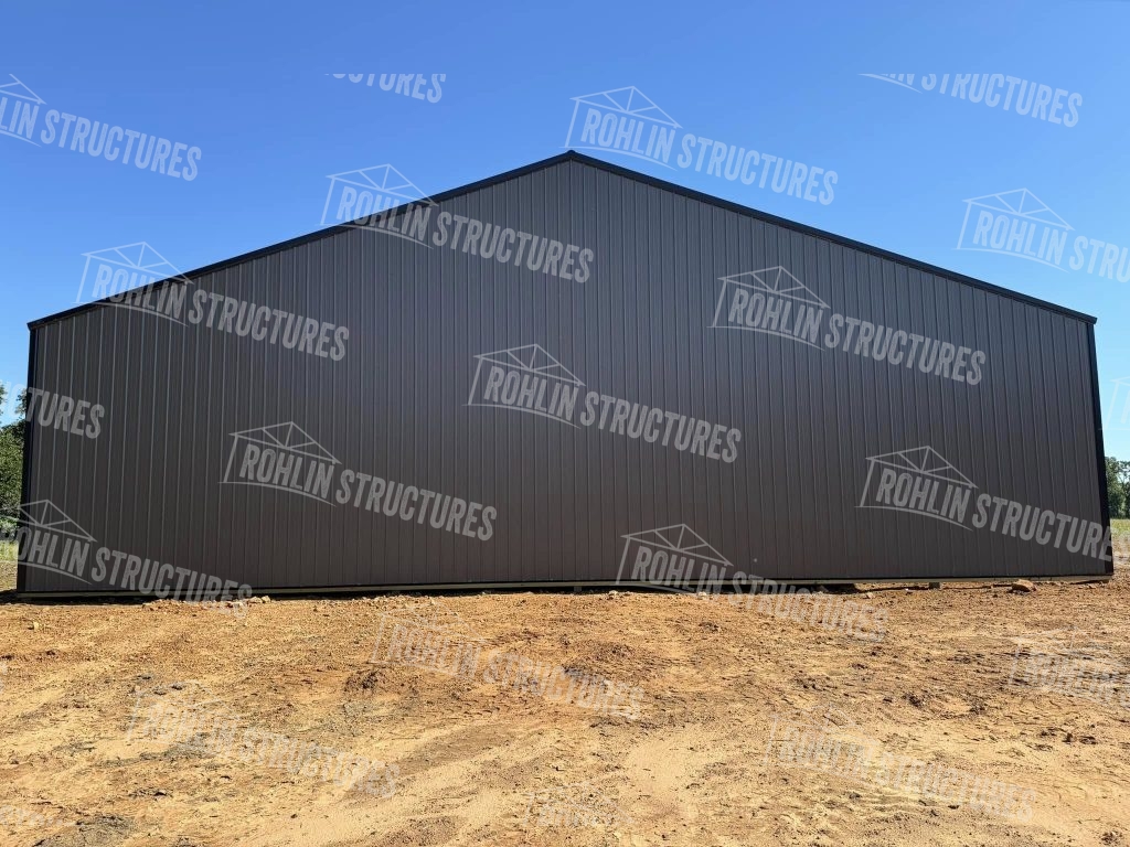 Large, dark gray equipment cover building by Rohlin Structures, featuring G-Rib metal siding.
