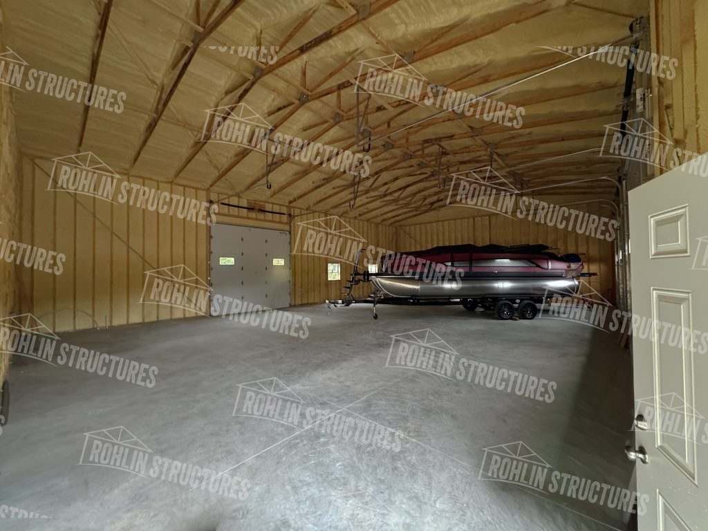 Interior view of a custom pole barn built by Rohlin Structures storing a boat.